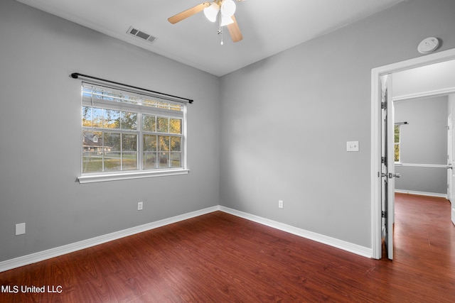 empty room featuring dark hardwood / wood-style floors and ceiling fan