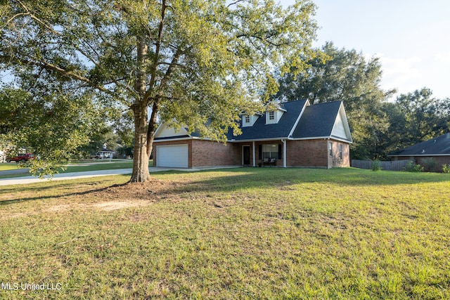 view of front of property with a front lawn and a garage