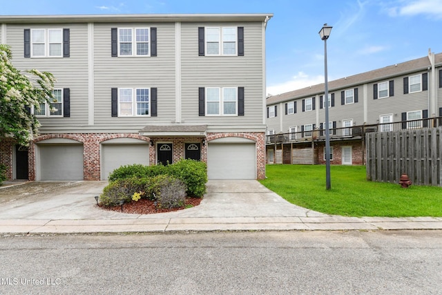 208 E Orchard Loop Unit 208, Diberville, MS 39540 - view of property with brick siding, an attached garage, and driveway