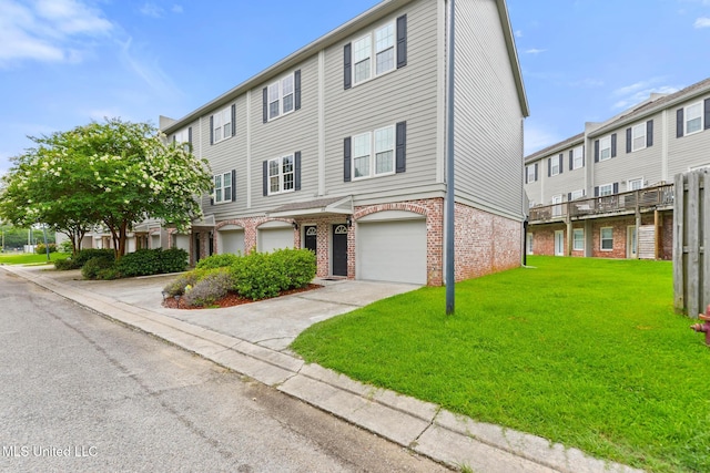 208 E Orchard Loop Unit 208, Diberville, MS 39540 - view of property with brick siding, a front yard, an attached garage, and driveway