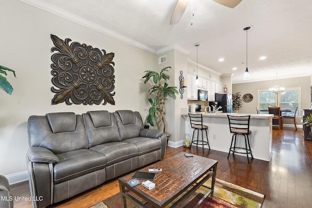208 E Orchard Loop Unit 208, Diberville, MS 39540 - living room with dark wood-style floors, ceiling fan, crown molding, a chandelier, and recessed lighting
