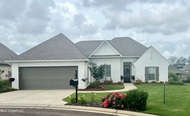 view of front of home with a front yard and a garage