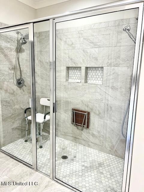 bathroom featuring a shower with door