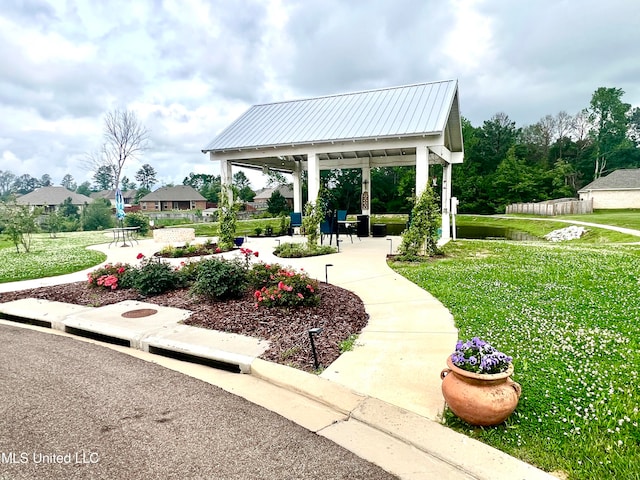 view of property's community with a gazebo, a yard, and a patio