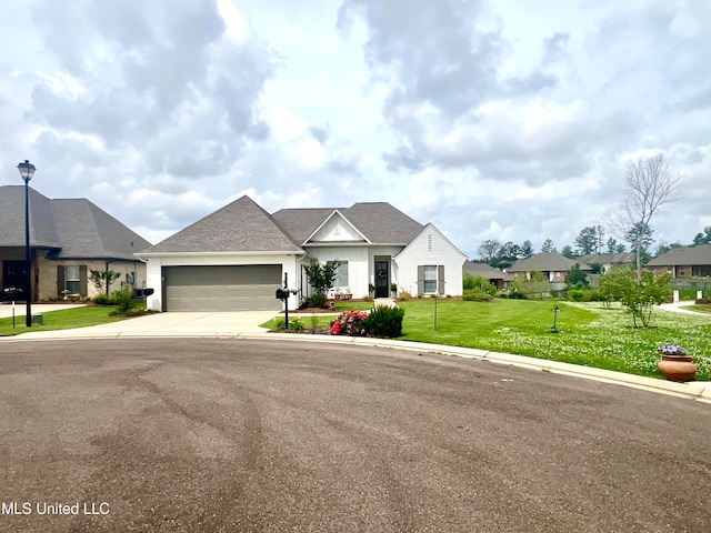 view of front of property with a garage and a front lawn