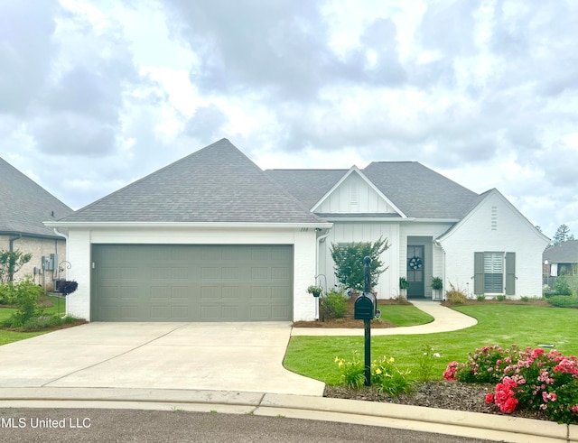 view of front of home with a front yard and a garage