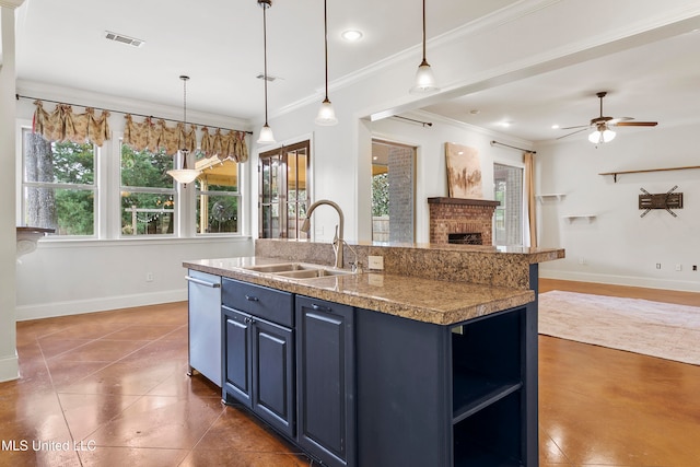 kitchen featuring blue cabinets, ceiling fan, crown molding, sink, and an island with sink