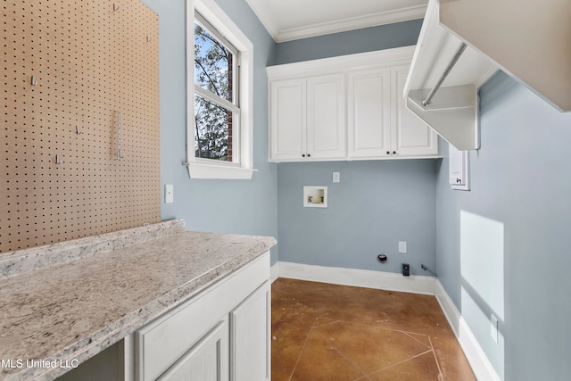 laundry area with dark tile patterned flooring, cabinets, crown molding, and hookup for a washing machine