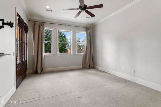 unfurnished room featuring light carpet, ceiling fan, and ornamental molding