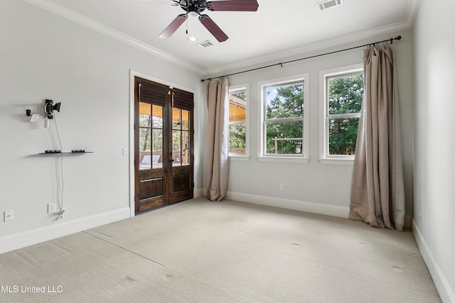 carpeted spare room featuring ceiling fan, french doors, and ornamental molding