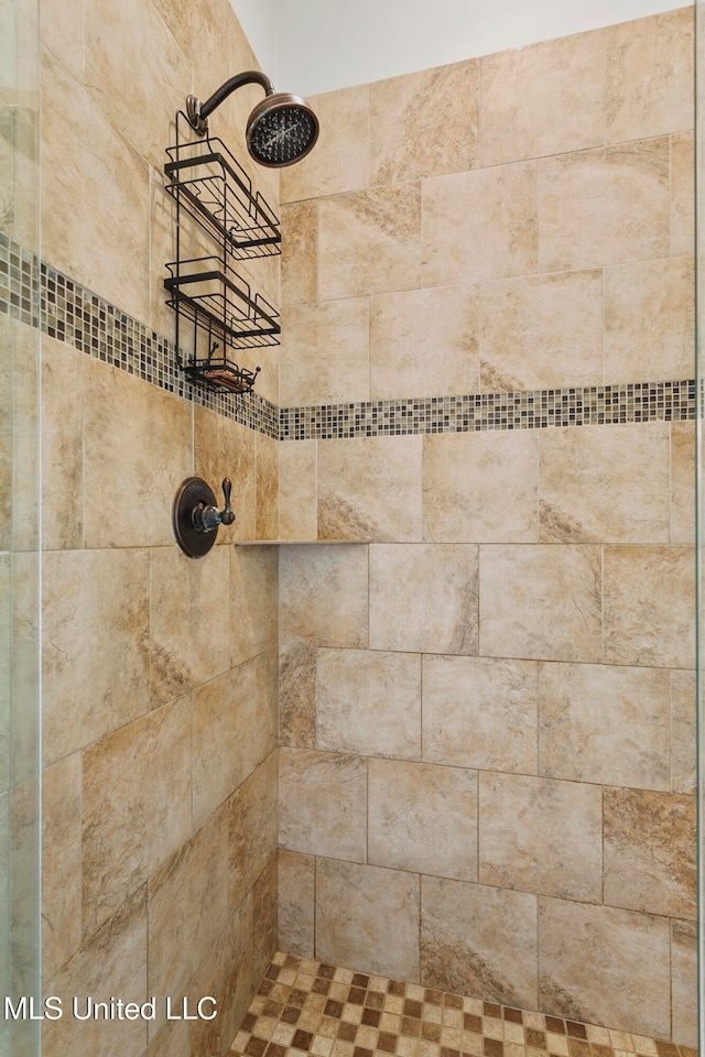 bathroom with a tile shower