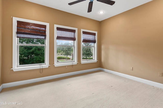 carpeted empty room featuring ceiling fan