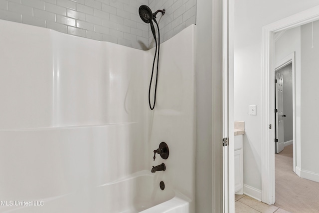 bathroom featuring vanity and  shower combination