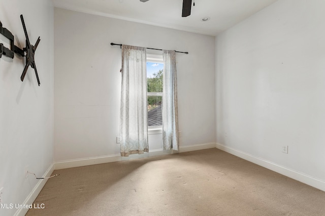 spare room with ceiling fan and carpet floors