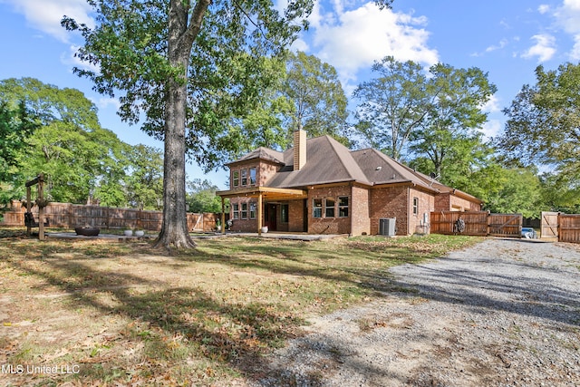 exterior space featuring central AC unit and a lawn