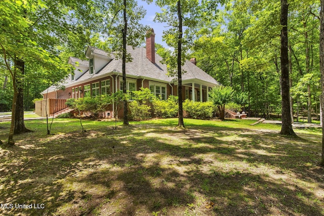 169 Pine Hill Dr, Brandon, MS 39047 - view of side of property with brick siding, a chimney, and a lawn