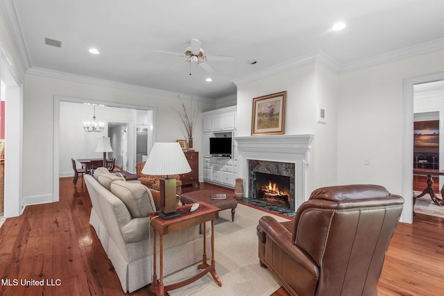 169 Pine Hill Dr, Brandon, MS 39047 - living room with a ceiling fan, light wood-type flooring, a high end fireplace, ornamental molding, and a chandelier