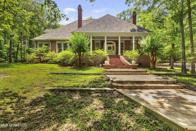 169 Pine Hill Dr, Brandon, MS 39047 - view of front of property featuring a chimney, a porch, brick siding, a front lawn, and a shingled roof