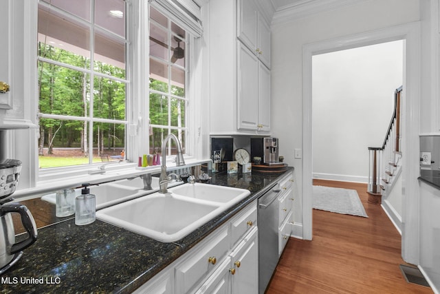 169 Pine Hill Dr, Brandon, MS 39047 - kitchen with stainless steel dishwasher, crown molding, white cabinetry, dark wood-style floors, and dark stone counters