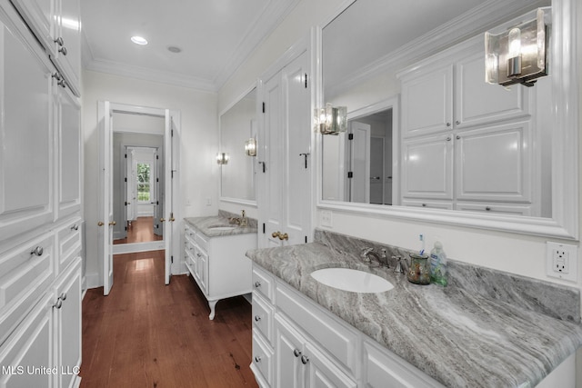 169 Pine Hill Dr, Brandon, MS 39047 - bathroom featuring two vanities, wood finished floors, recessed lighting, and ornamental molding