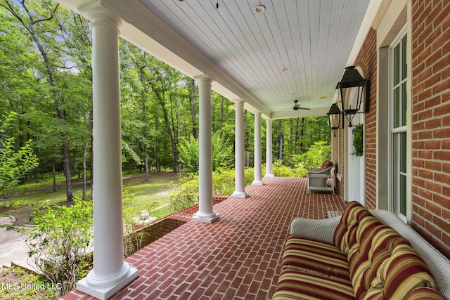 169 Pine Hill Dr, Brandon, MS 39047 - porch with a ceiling fan and view of wooded area