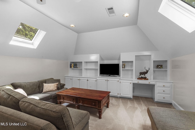 169 Pine Hill Dr, Brandon, MS 39047 - living room featuring a skylight, vaulted ceiling, light colored carpet, and built in shelves