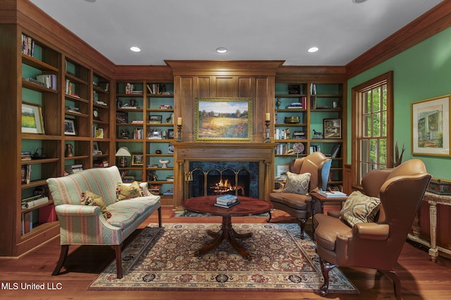 169 Pine Hill Dr, Brandon, MS 39047 - living area featuring ornamental molding, wood finished floors, a fireplace, built in features, and recessed lighting