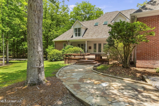 169 Pine Hill Dr, Brandon, MS 39047 - new england style home with french doors, brick siding, a front lawn, and a shingled roof