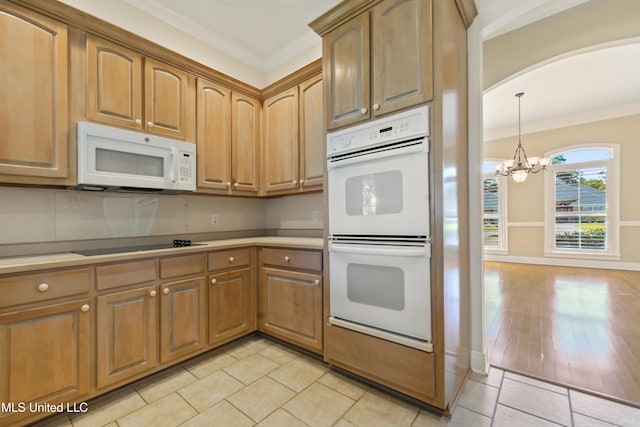 426 Carmargue Ln, Biloxi, MS 39531 - kitchen with white appliances, arched walkways, a chandelier, ornamental molding, and light tile patterned floors