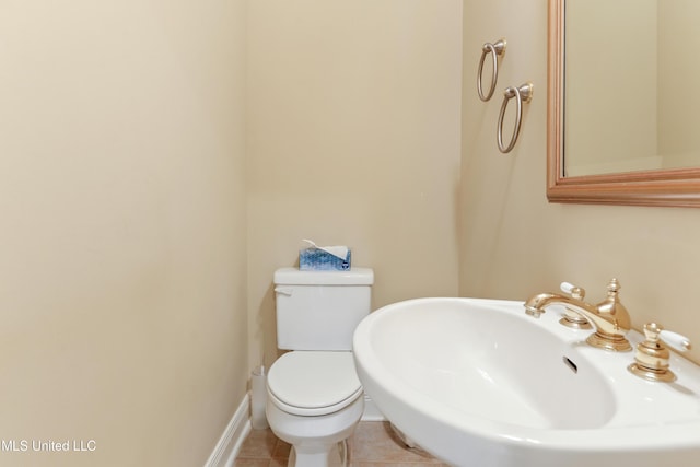 426 Carmargue Ln, Biloxi, MS 39531 - half bath featuring toilet, a sink, and tile patterned flooring