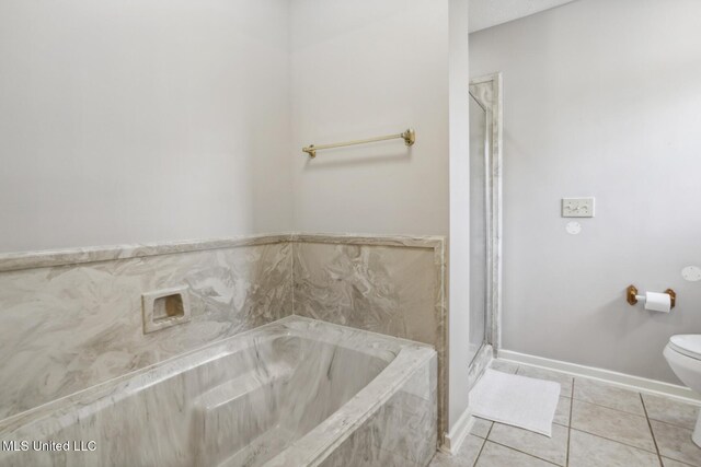 bathroom with tile patterned flooring, separate shower and tub, and toilet