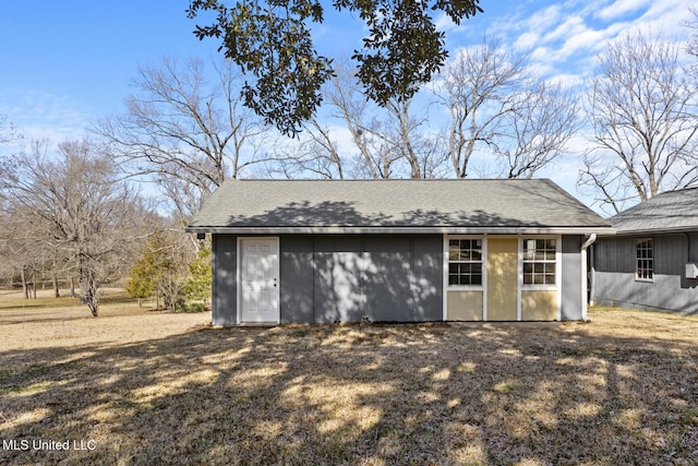 exterior space with a yard and an outbuilding