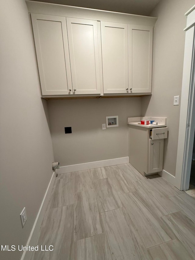 clothes washing area featuring cabinets and washer hookup