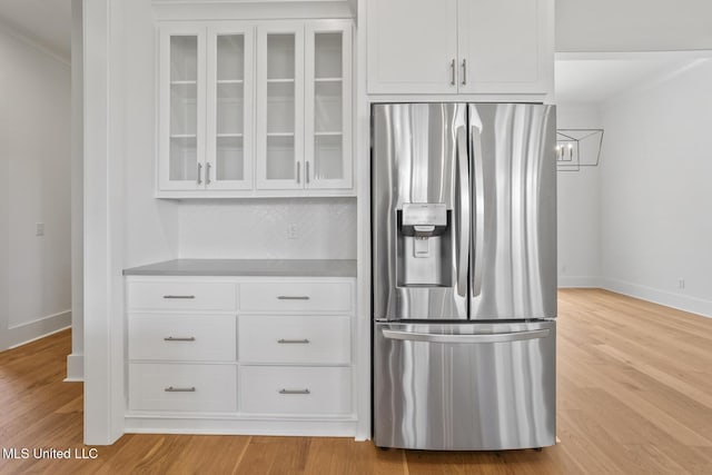 119 Paylors Way, Madison, MS 39110 - kitchen featuring stainless steel fridge, glass insert cabinets, white cabinetry, and ornamental molding