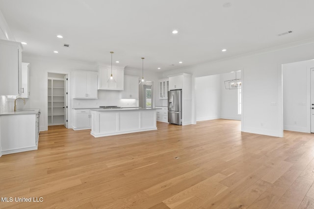 119 Paylors Way, Madison, MS 39110 - kitchen with stainless steel fridge with ice dispenser, crown molding, white cabinets, open floor plan, and light wood-type flooring