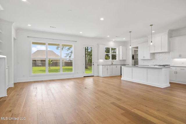 119 Paylors Way, Madison, MS 39110 - kitchen with healthy amount of natural light, decorative backsplash, light wood-type flooring, ornamental molding, and recessed lighting