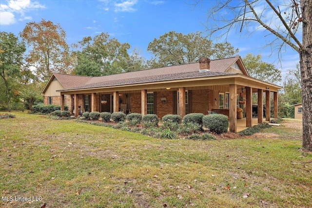 view of side of home featuring a yard and a porch