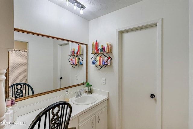 bathroom featuring vanity, a textured ceiling, and curtained shower