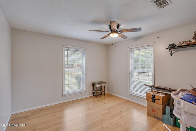 misc room with light hardwood / wood-style floors and ceiling fan