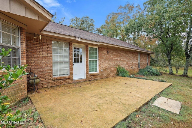 exterior space featuring a patio area and a lawn