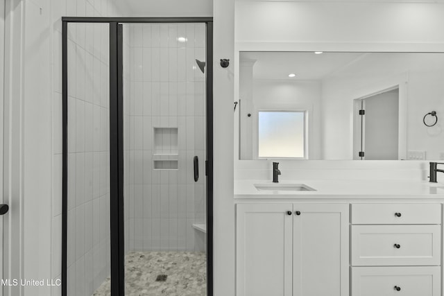 bathroom with vanity and a shower with shower door