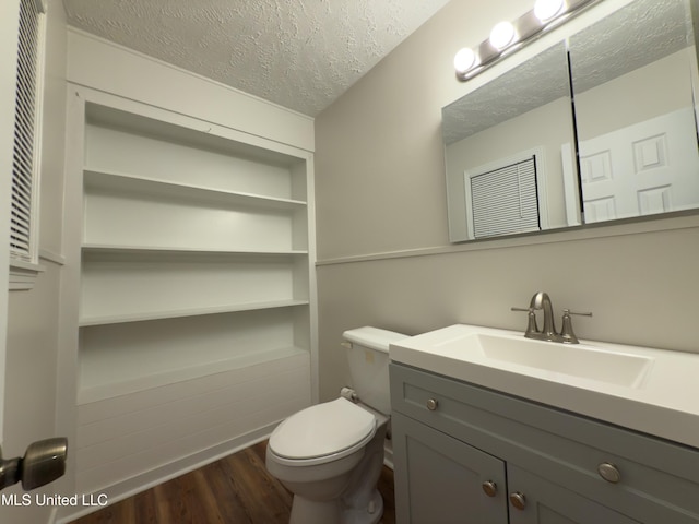 138 William Mckinley Cir, Jackson, MS 39213 - half bath featuring a textured ceiling, vanity, wood finished floors, and toilet