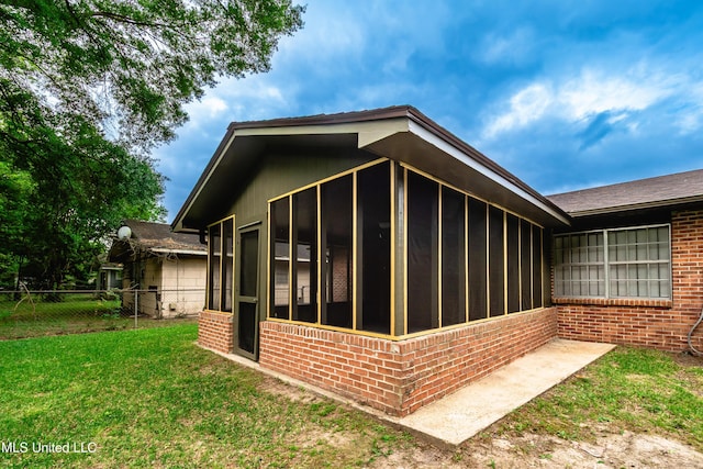 138 William Mckinley Cir, Jackson, MS 39213 - view of property exterior with brick siding and a sunroom