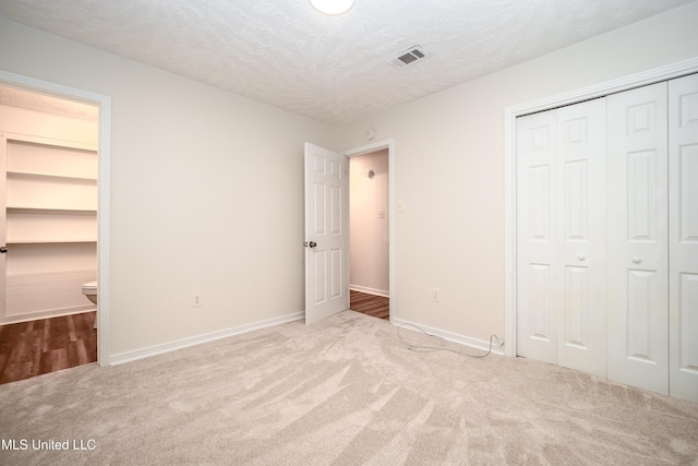138 William Mckinley Cir, Jackson, MS 39213 - unfurnished bedroom featuring carpet flooring, baseboards, a textured ceiling, and a closet