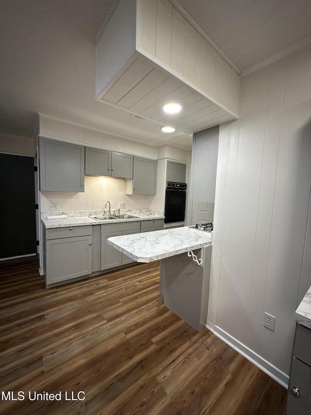 138 William Mckinley Cir, Jackson, MS 39213 - kitchen with gray cabinets, a sink, crown molding, dark wood finished floors, and stainless steel gas stovetop