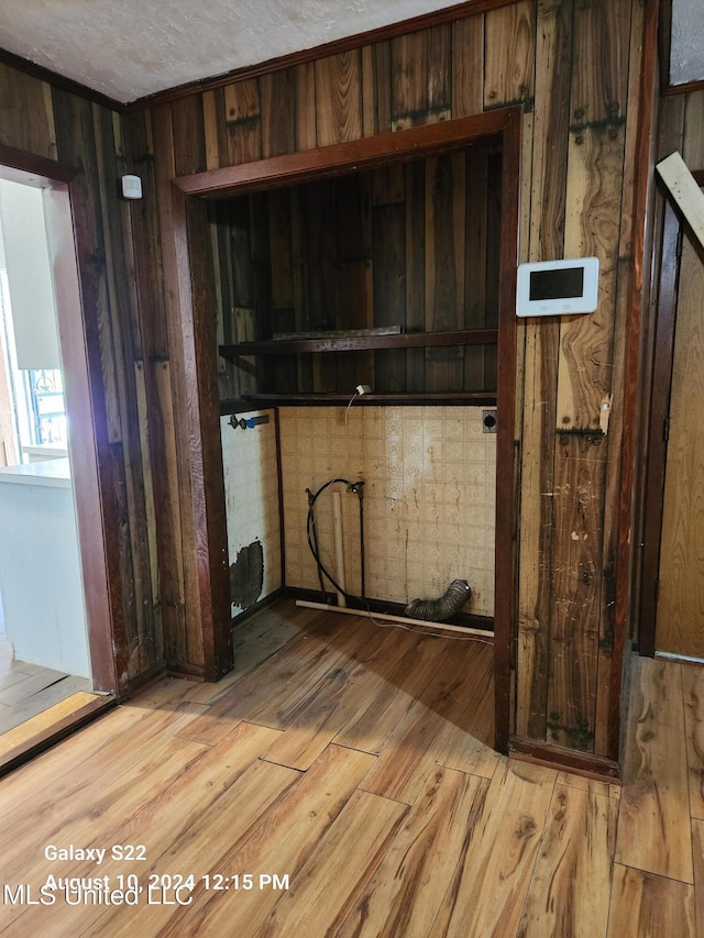 interior space featuring light hardwood / wood-style floors and wood walls