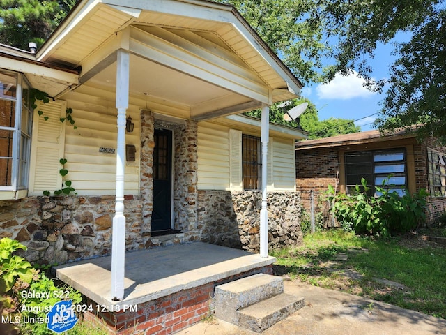 doorway to property featuring a porch