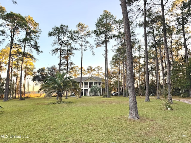 yard at dusk featuring covered porch