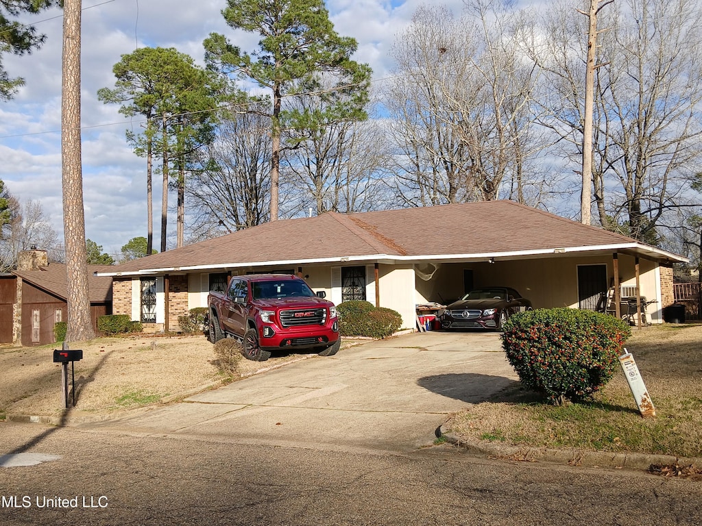 ranch-style home featuring a carport