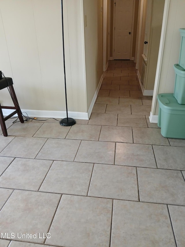 corridor featuring light tile patterned floors